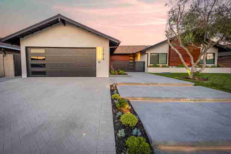 Modern home with a sleek driveway and landscaped yard in Fountain Valley, CA.