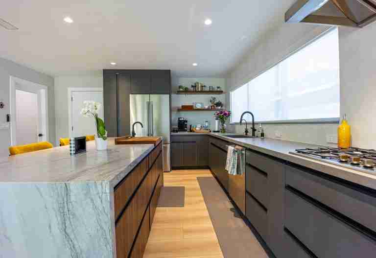 Beautifully remodeled kitchen with sleek dark cabinets and a spacious island. Perfect for family time Anaheim, CA.