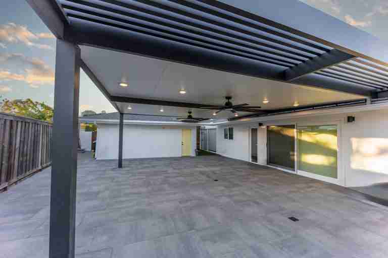 Outdoor patio with modern roofing and ceiling fans in Costa Mesa, CA.