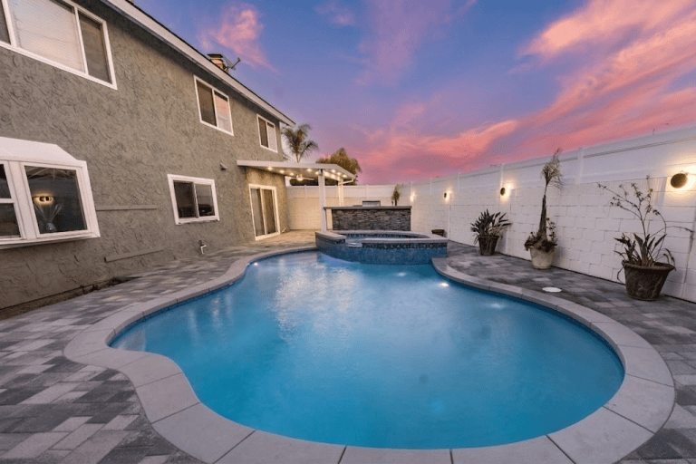 Pool and spa area in a modern backyard during sunset Huntington beach ca