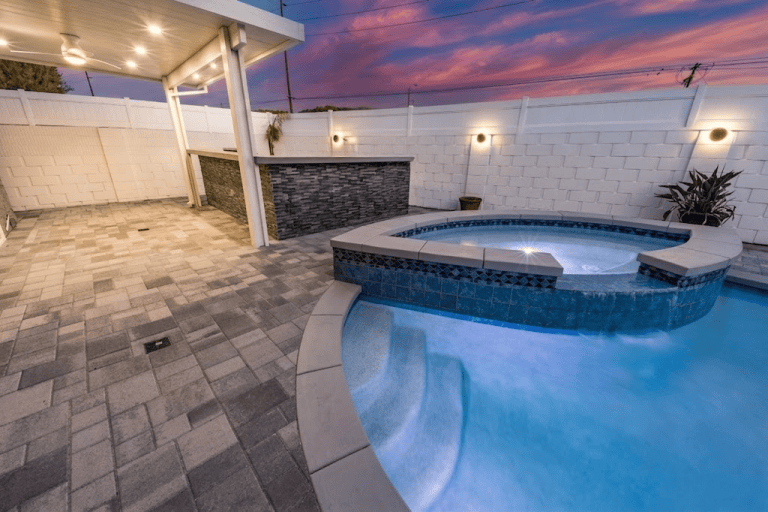 Pool with built-in spa and ambient lighting at dusk in Fullerton CA
