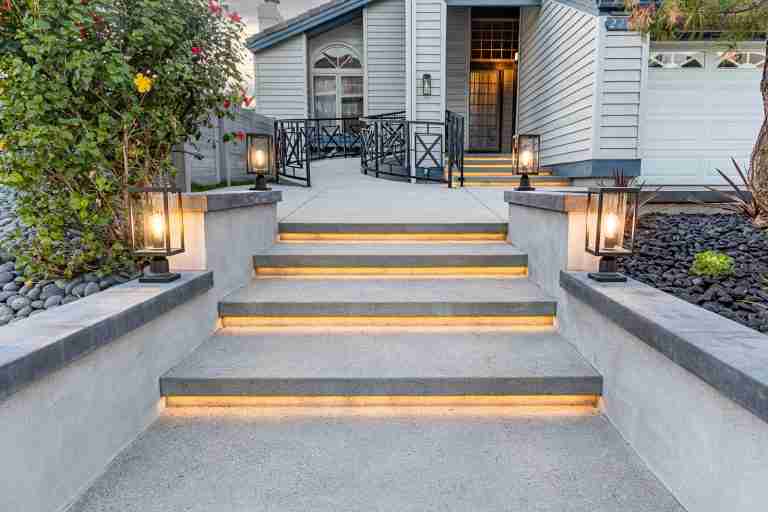 front yard remodeling in orange ca Brightly lit concrete stairs leading to a charming home entrance with modern outdoor lighting and we in Orange CA