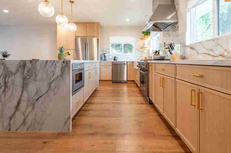 kitchen remodeling open concept orange ca Modern kitchen with wooden cabinets, marble countertops, and stainless steel appliances in Orange CA