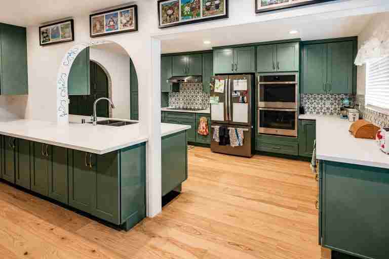 Modern green kitchen in tustin CA with island and appliances.