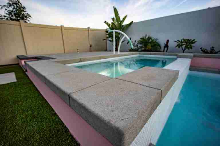 Modern backyard pool in Tustin CA with landscaping.